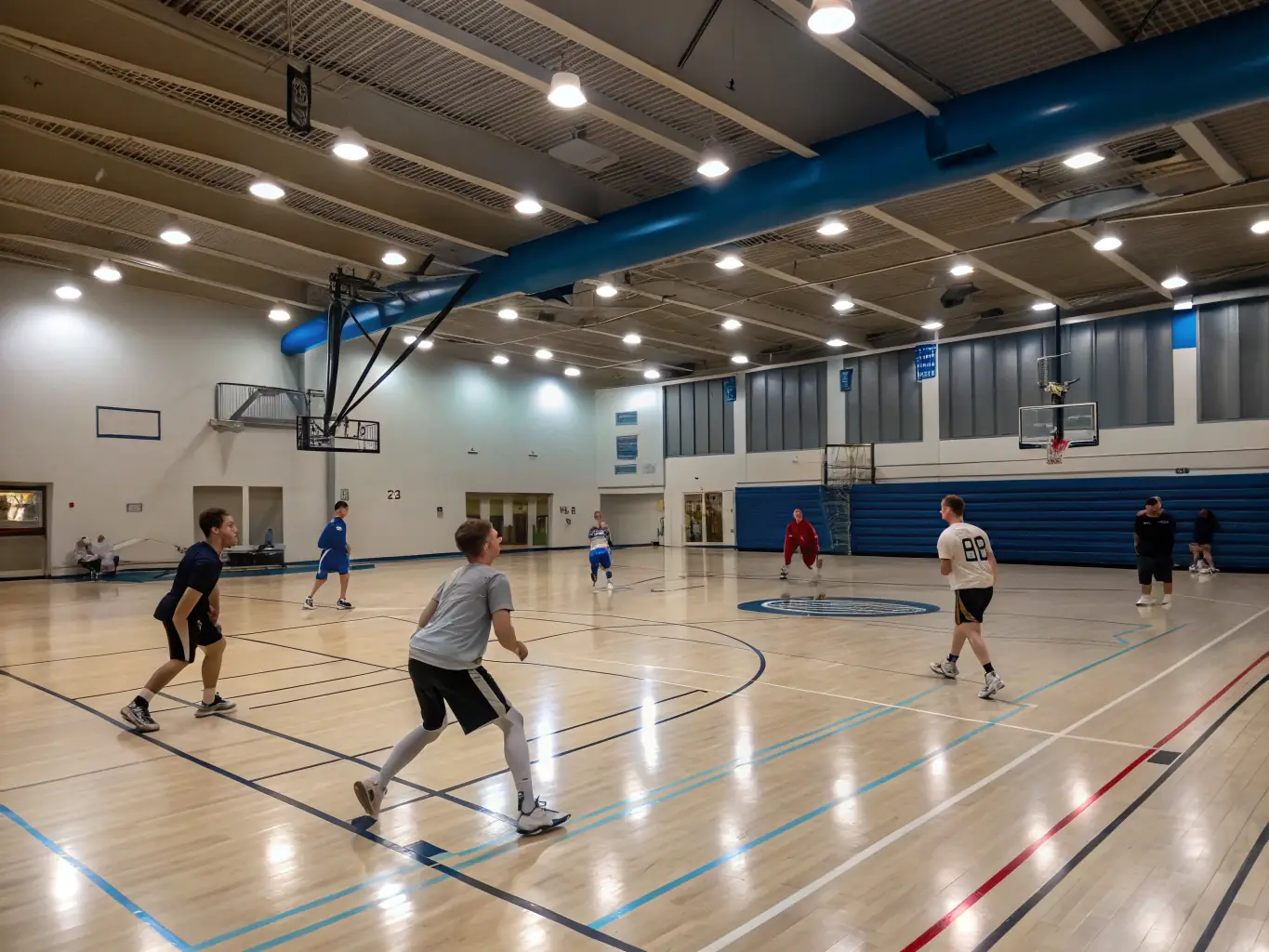 A vibrant image of adults playing basketball in an indoor court, highlighting fitness and social interaction.